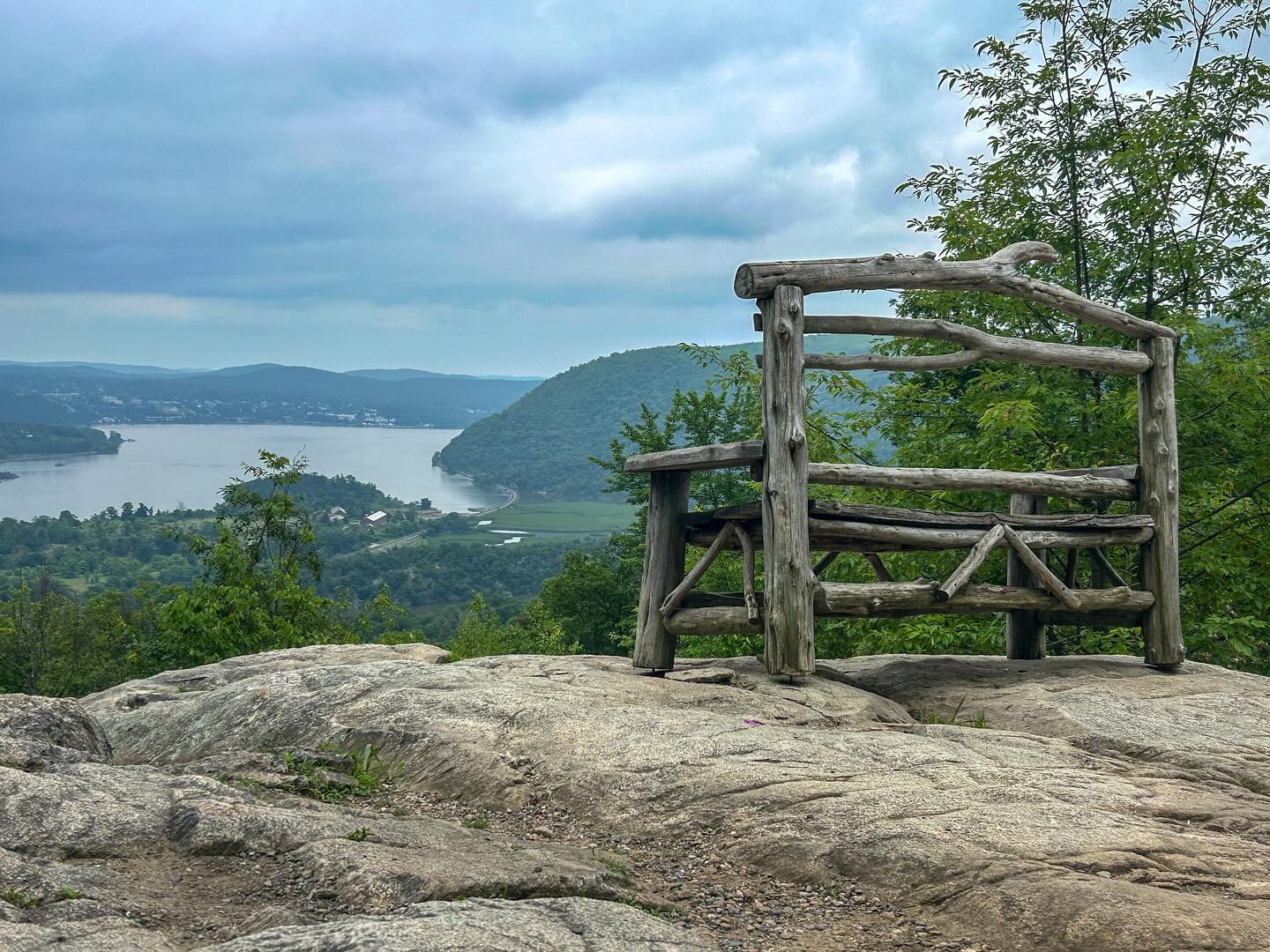 Landscape overlook with rustic wood bench overlooking a river valley