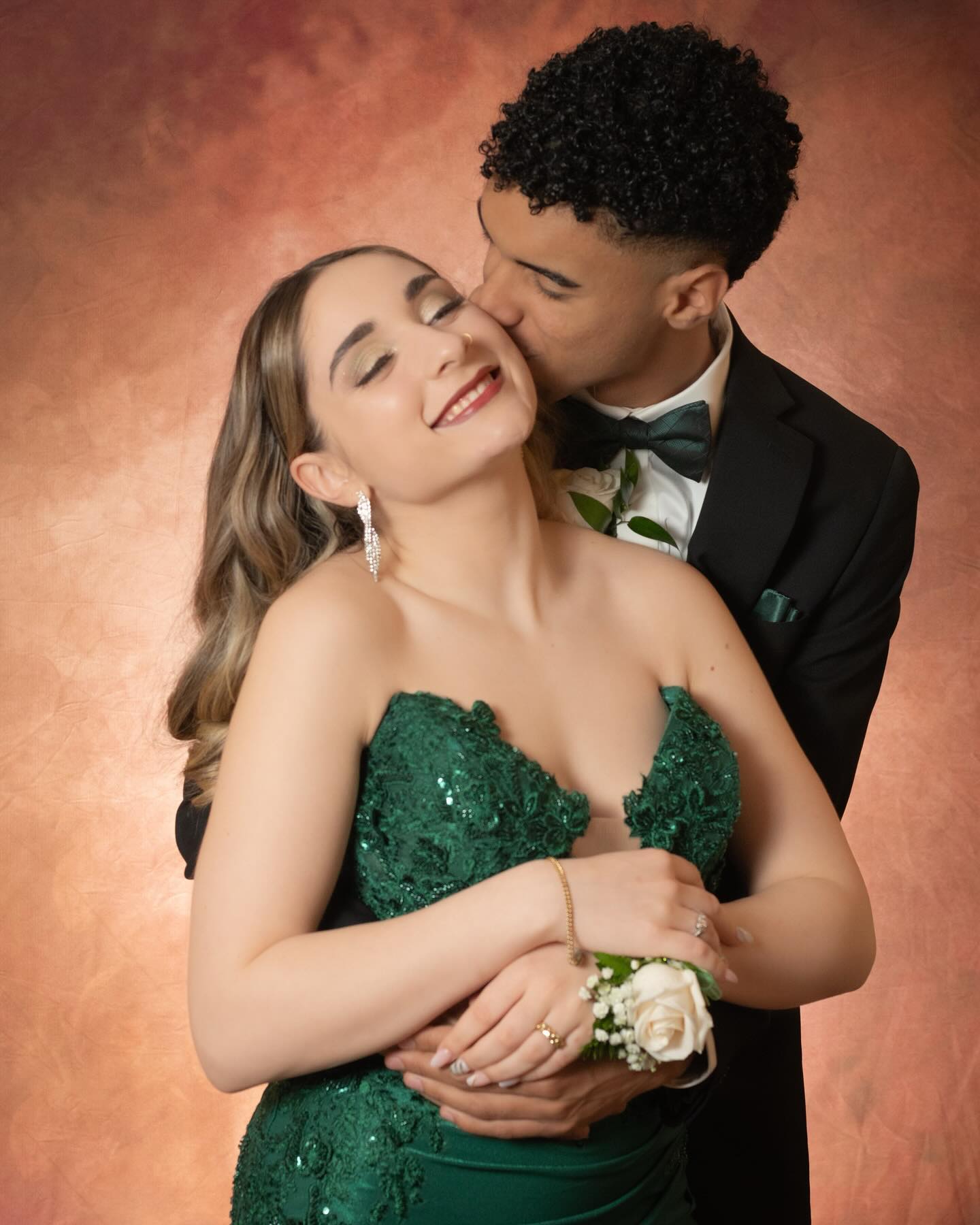 Studio portrait of a formal couple, woman in a green dress