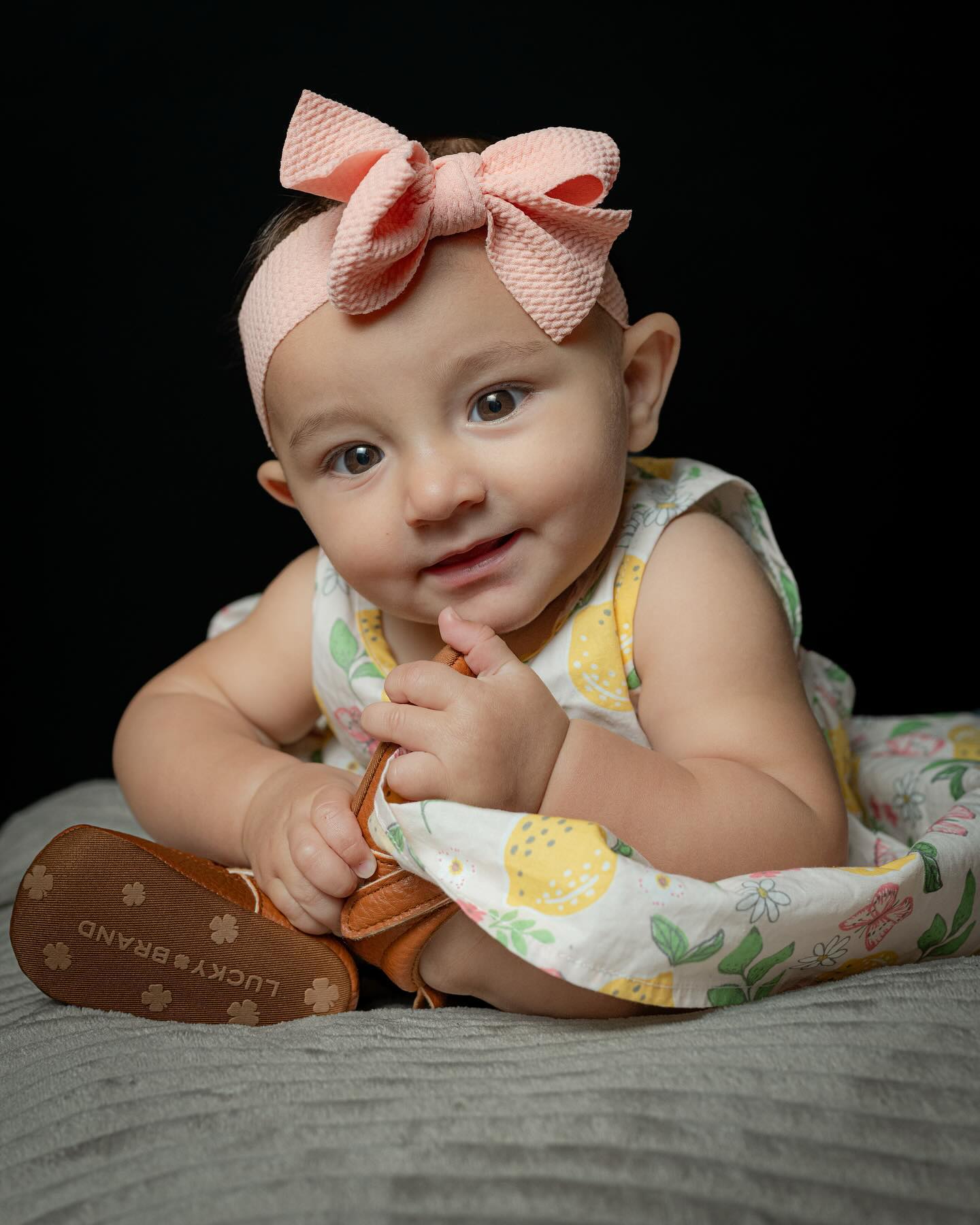 Studio baby portrait against a dark background