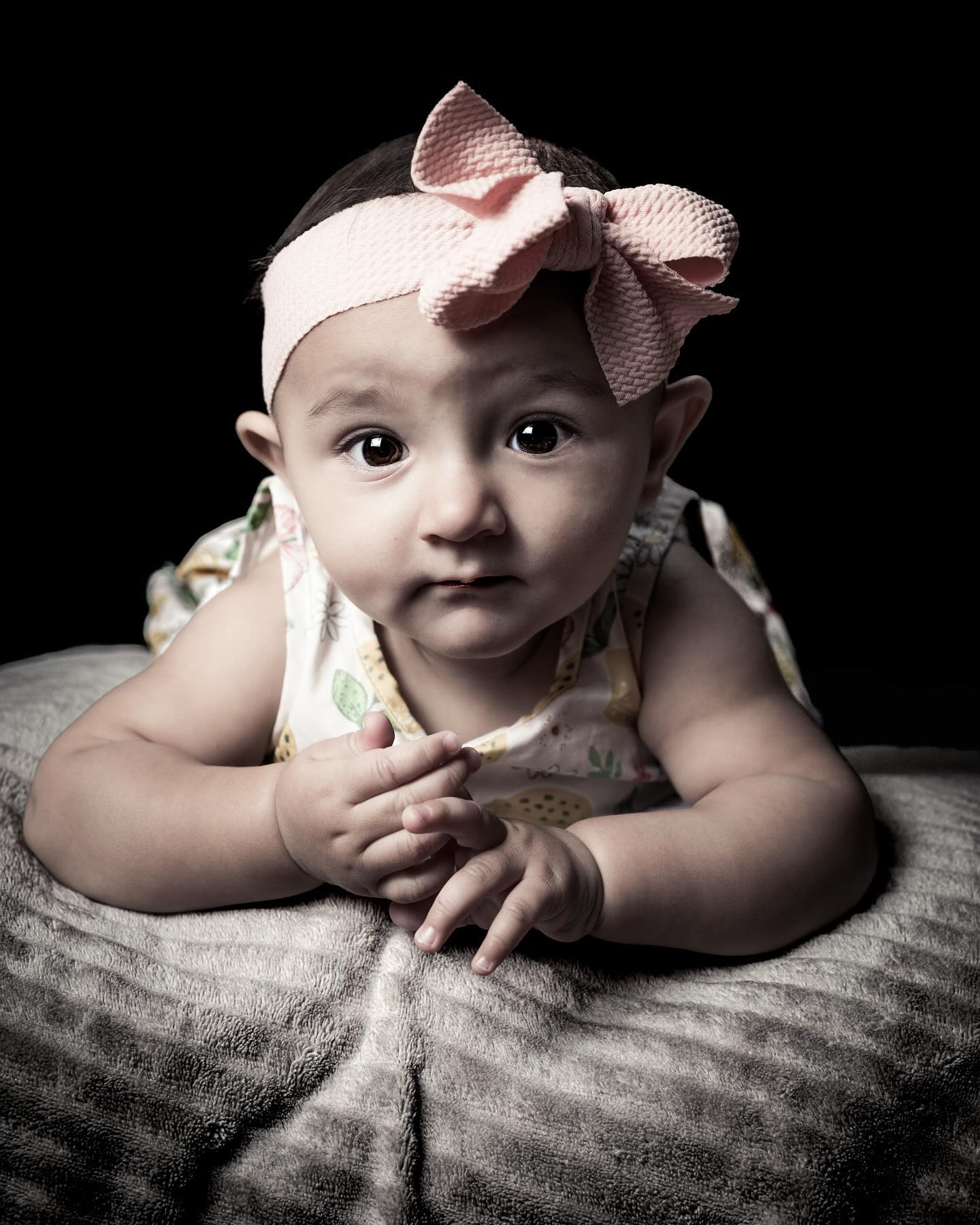 Close-up baby portrait against a dark background